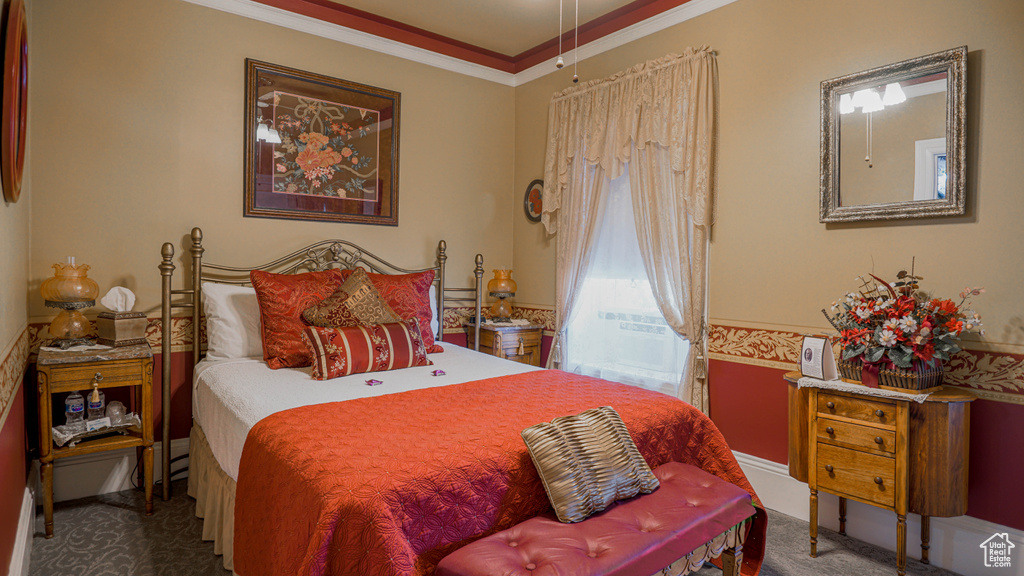 Bedroom featuring crown molding and carpet flooring