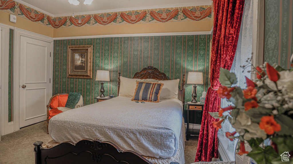 Carpeted bedroom with crown molding