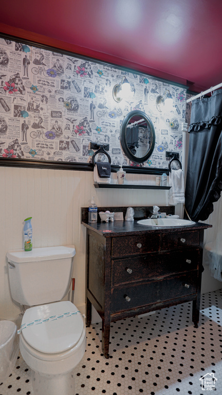 Bathroom with vanity, toilet, and tile floors