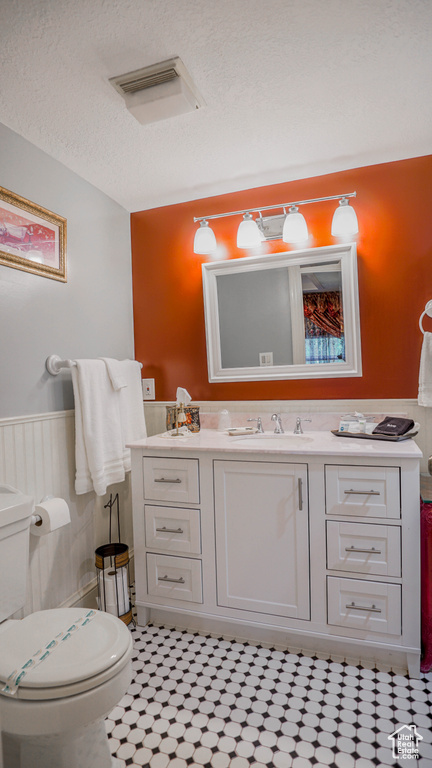 Bathroom with tile flooring, toilet, and vanity