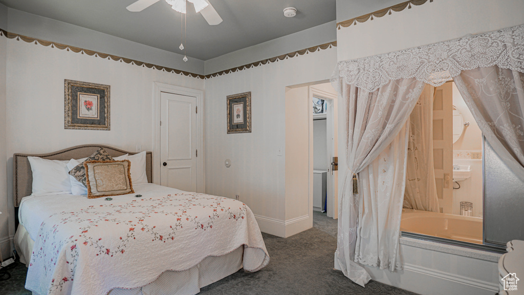 Carpeted bedroom featuring ceiling fan