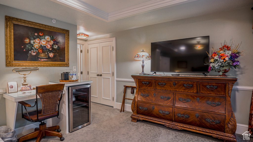 Carpeted home office featuring wine cooler, a tray ceiling, and crown molding