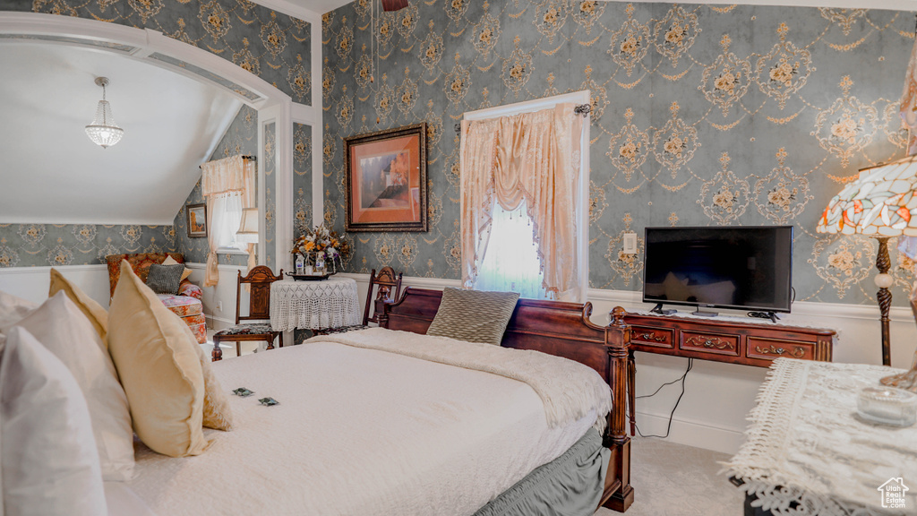 Bedroom featuring lofted ceiling