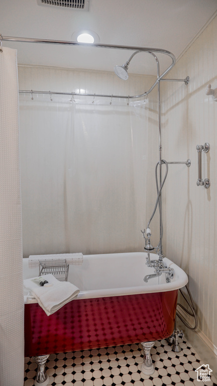 Bathroom with tile flooring and shower / bath combination