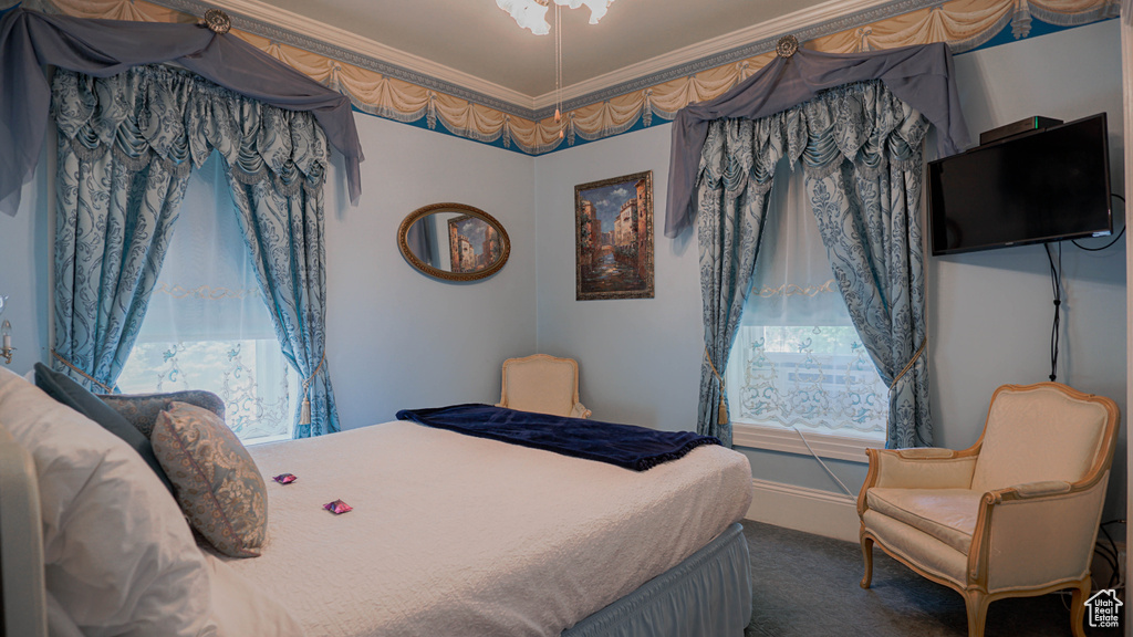 Bedroom with carpet floors and crown molding