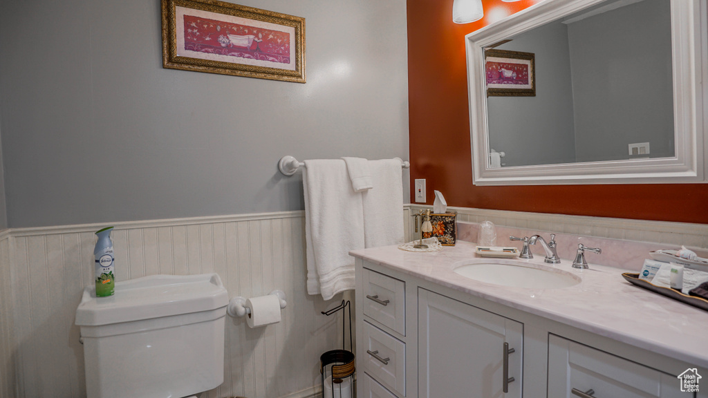 Bathroom with toilet and vanity with extensive cabinet space