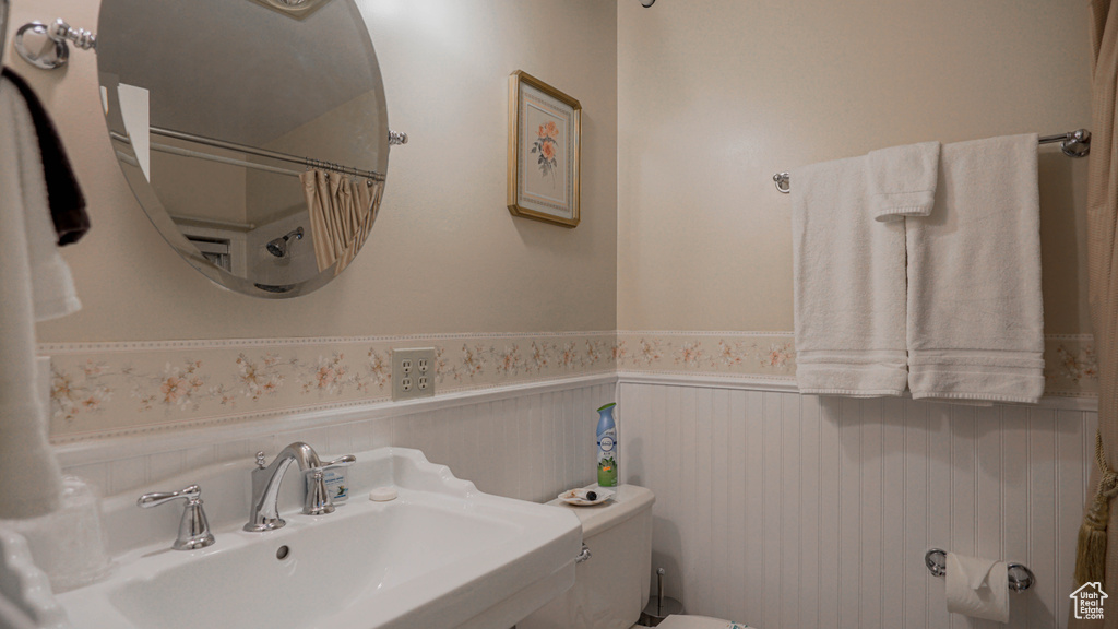 Bathroom featuring sink and toilet