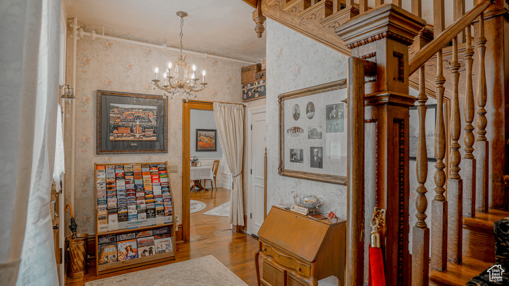 Hallway with a chandelier and wood-type flooring