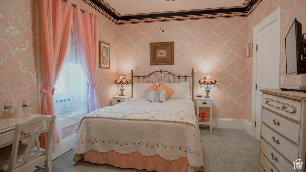 Bedroom featuring ornamental molding and carpet floors