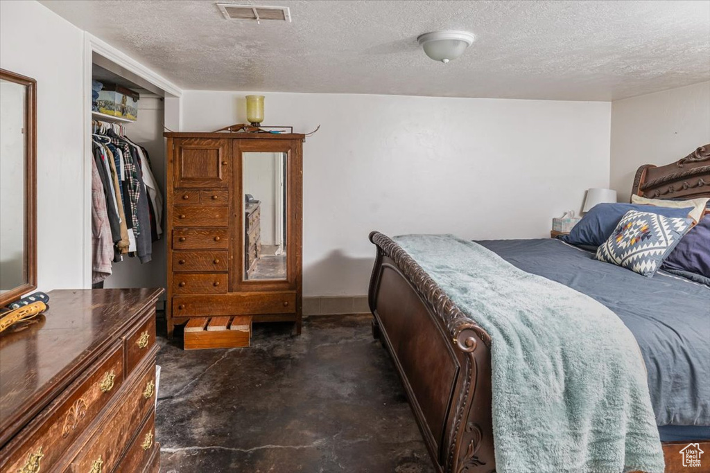 Bedroom featuring a closet and a textured ceiling