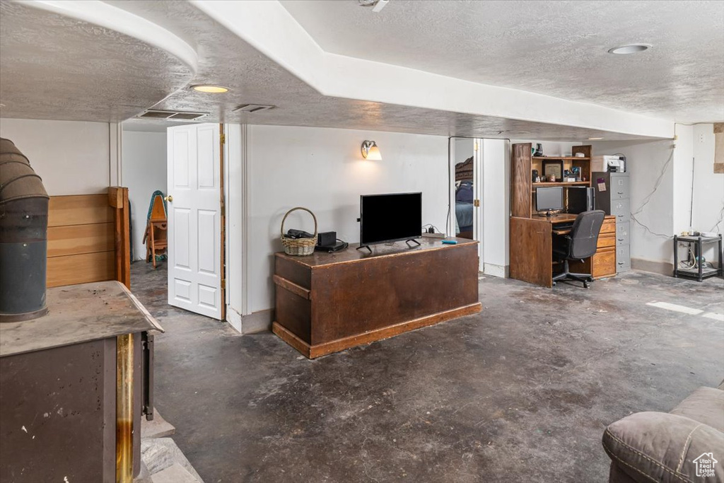 Living room with concrete flooring and a textured ceiling