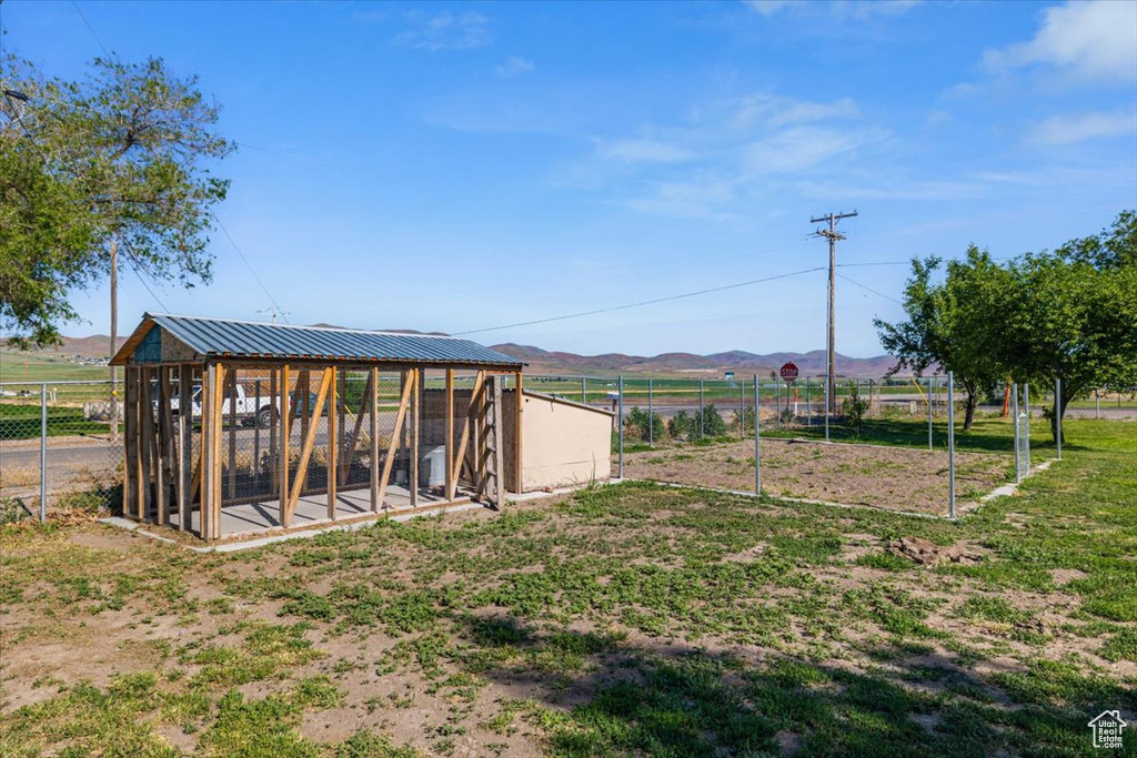 View of yard featuring an outdoor structure, a mountain view, and a rural view