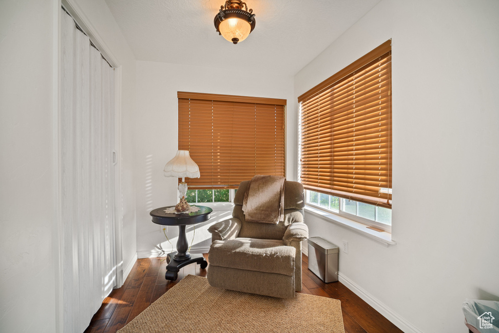 Sitting room with dark hardwood / wood-style flooring