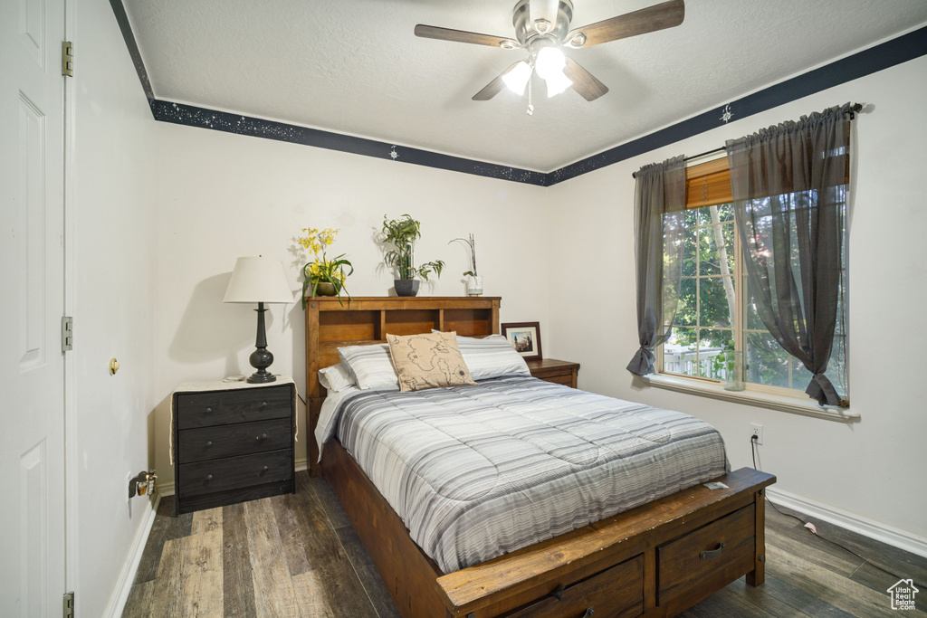 Bedroom featuring dark hardwood / wood-style flooring and ceiling fan