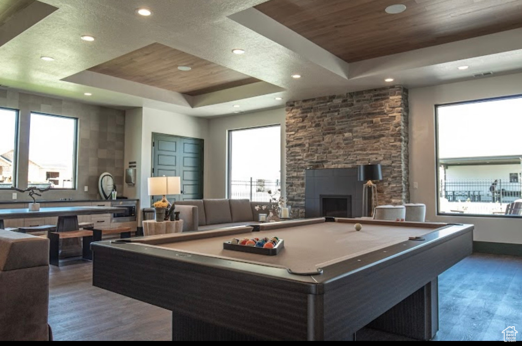Rec room with a healthy amount of sunlight, pool table, and a tray ceiling