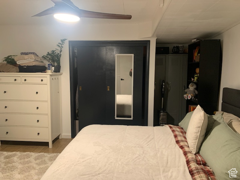 Bedroom featuring ceiling fan and light hardwood / wood-style flooring