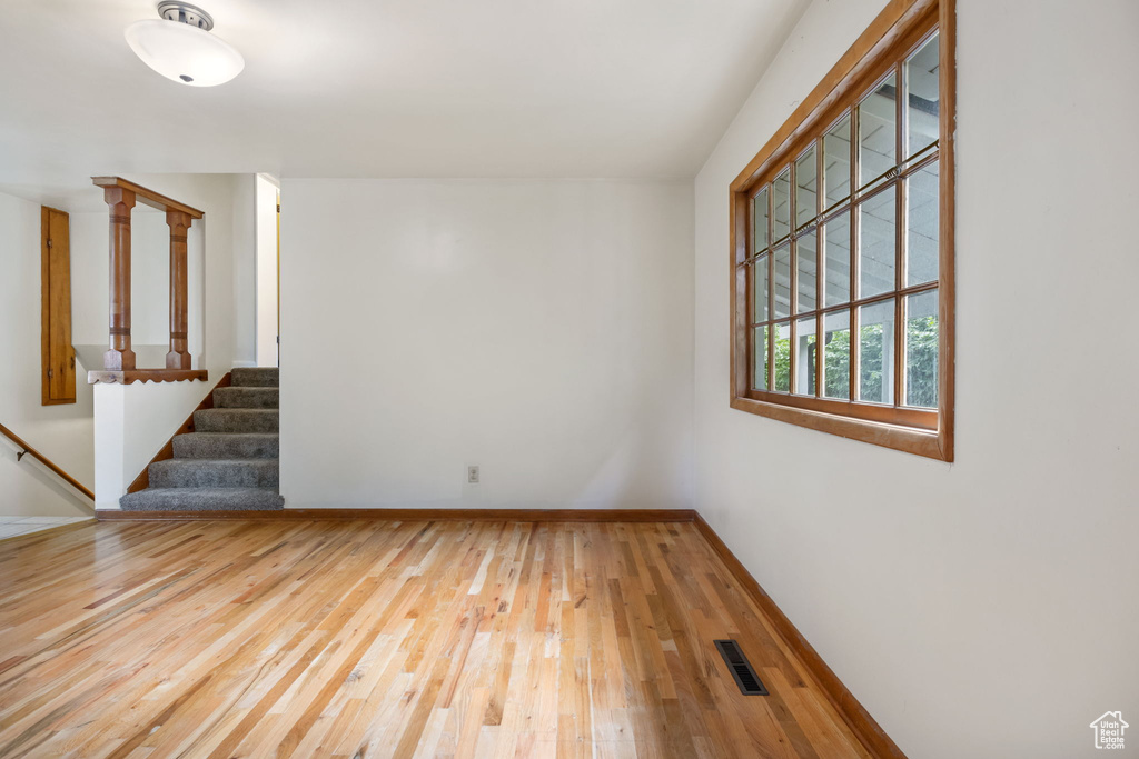 Unfurnished room with hardwood / wood-style floors