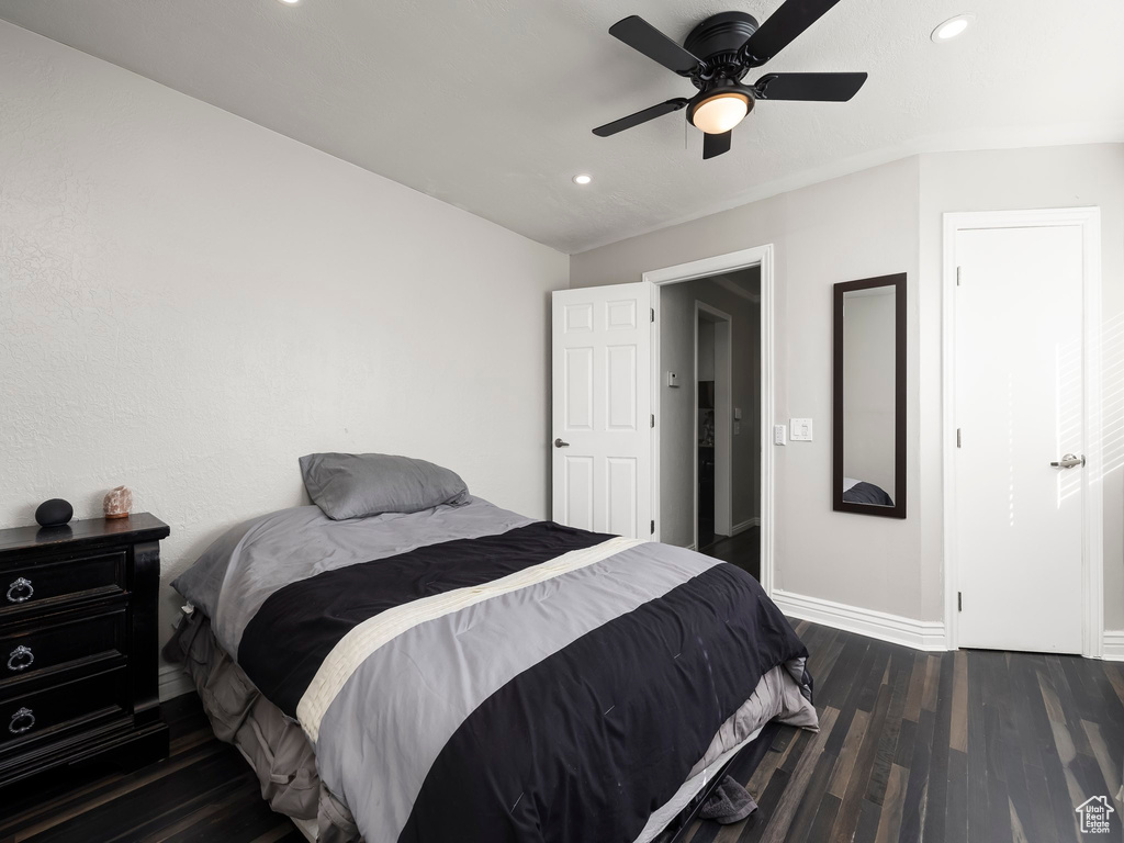 Bedroom with ceiling fan and dark wood-type flooring