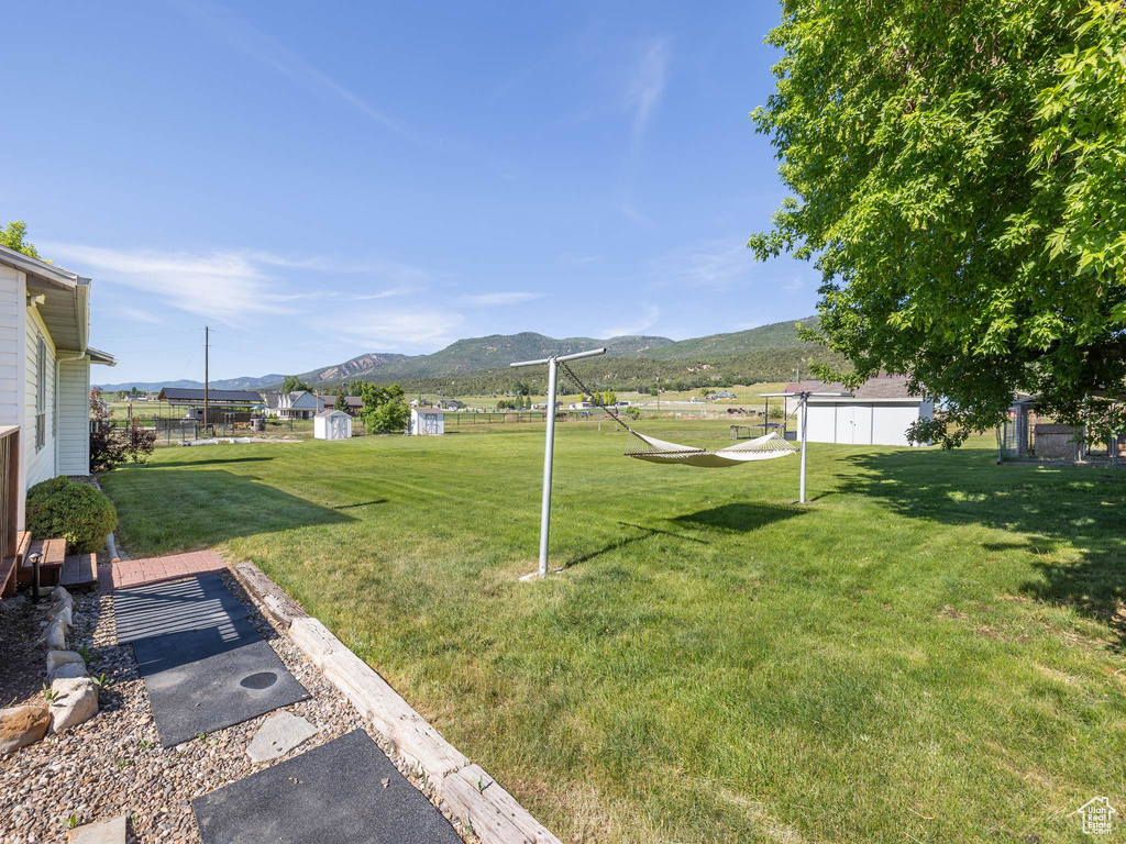 View of yard featuring a storage unit and a mountain view