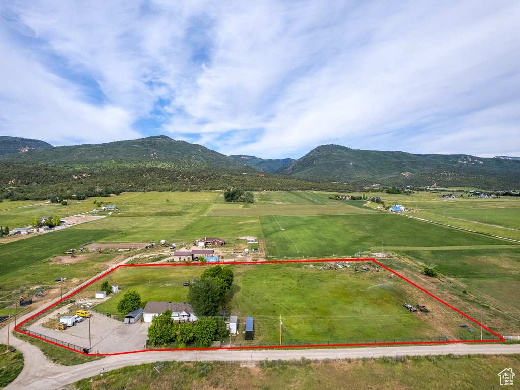 Birds eye view of property with a mountain view and a rural view