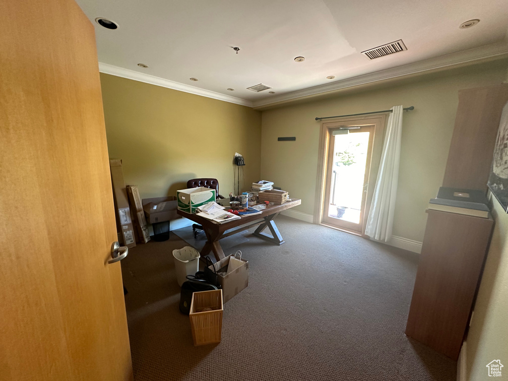 Carpeted home office with ornamental molding