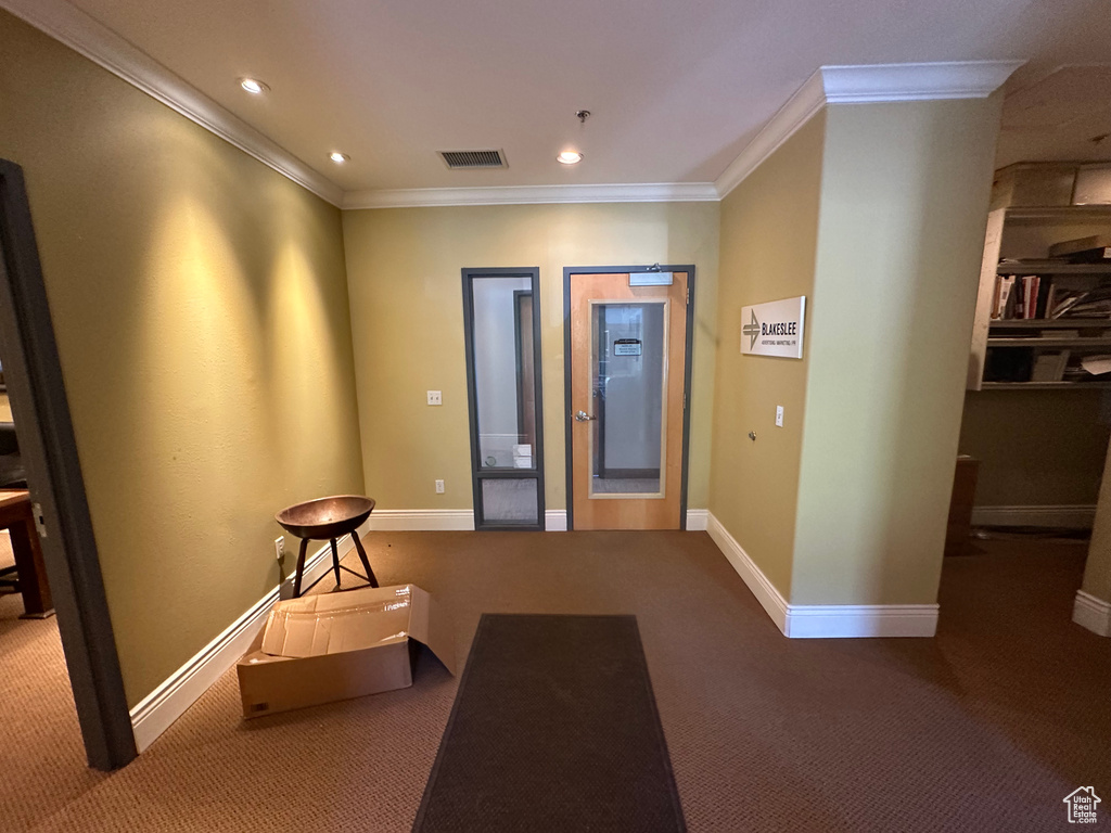 Interior space with carpet floors and crown molding