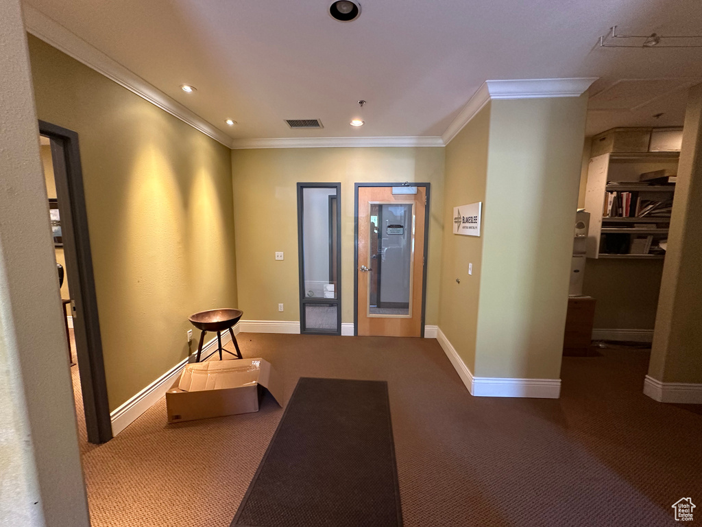 Interior space featuring carpet floors and crown molding