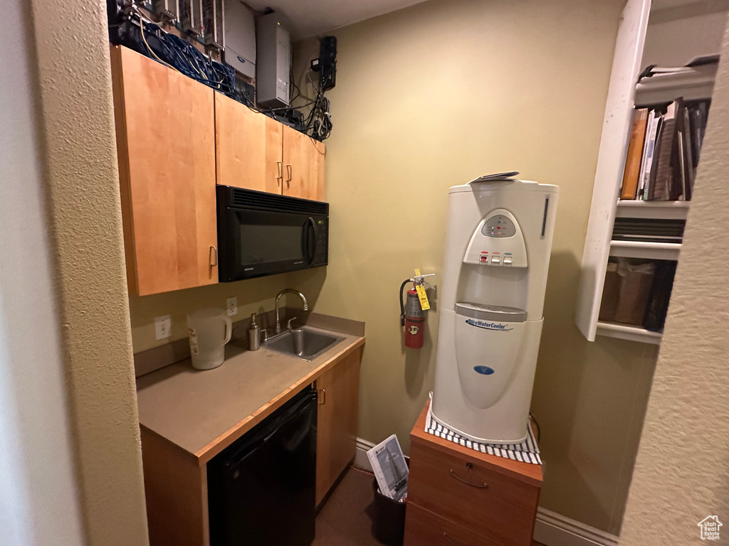 Kitchen featuring black appliances, sink, and light brown cabinets