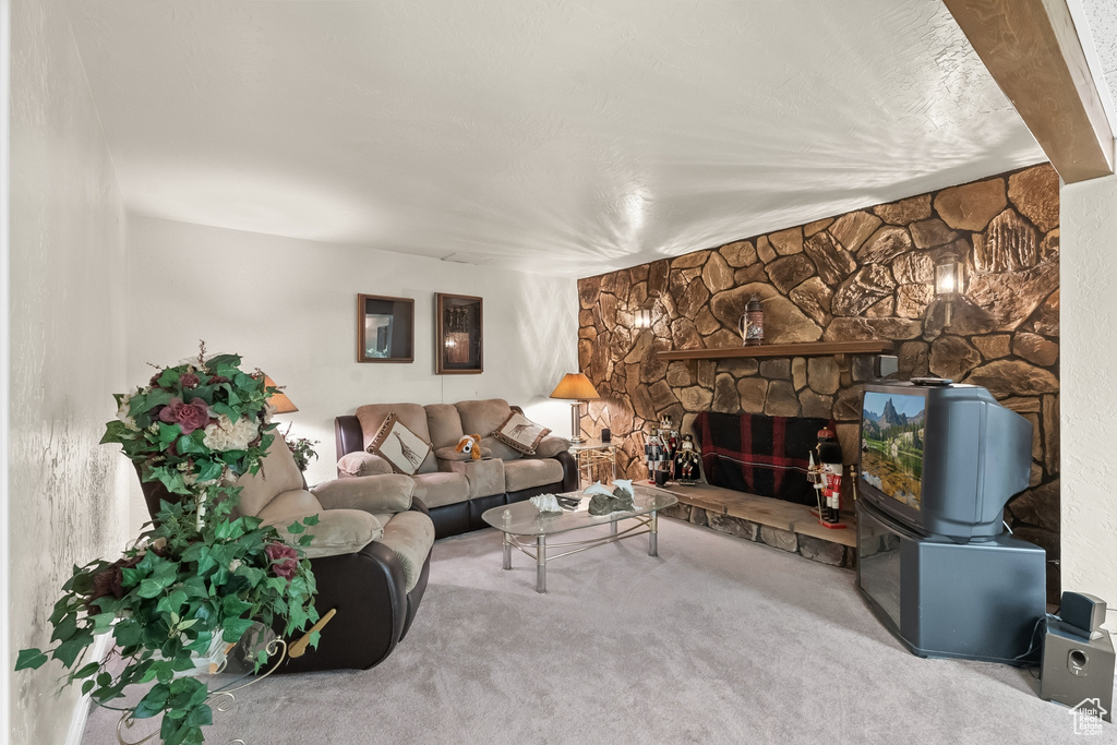 Carpeted living room with a fireplace