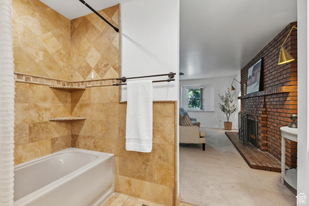 Bathroom with tile patterned floors, independent shower and bath, and a fireplace