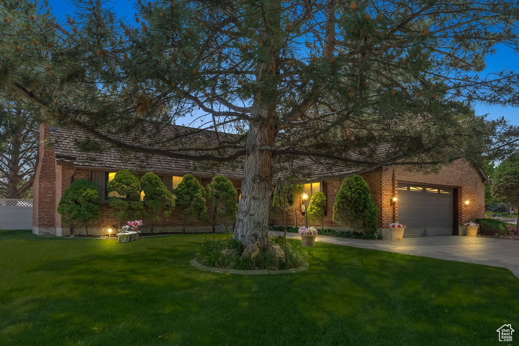 View of front of home featuring a garage and a front lawn