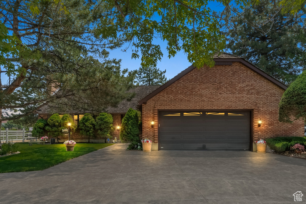 View of front facade with a front yard and a garage