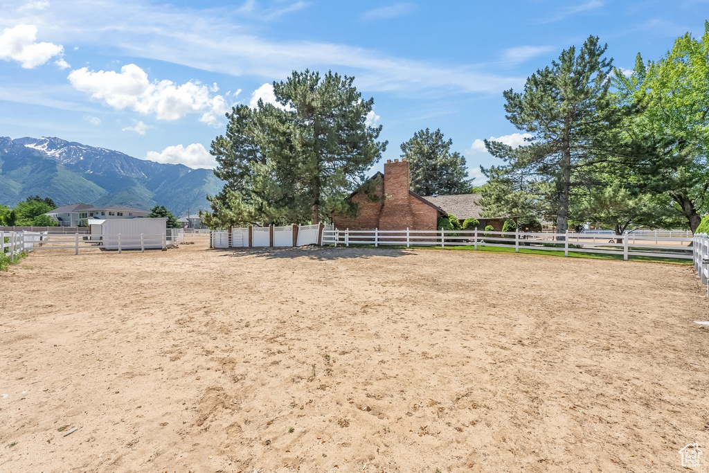 View of yard with a rural view and a mountain view