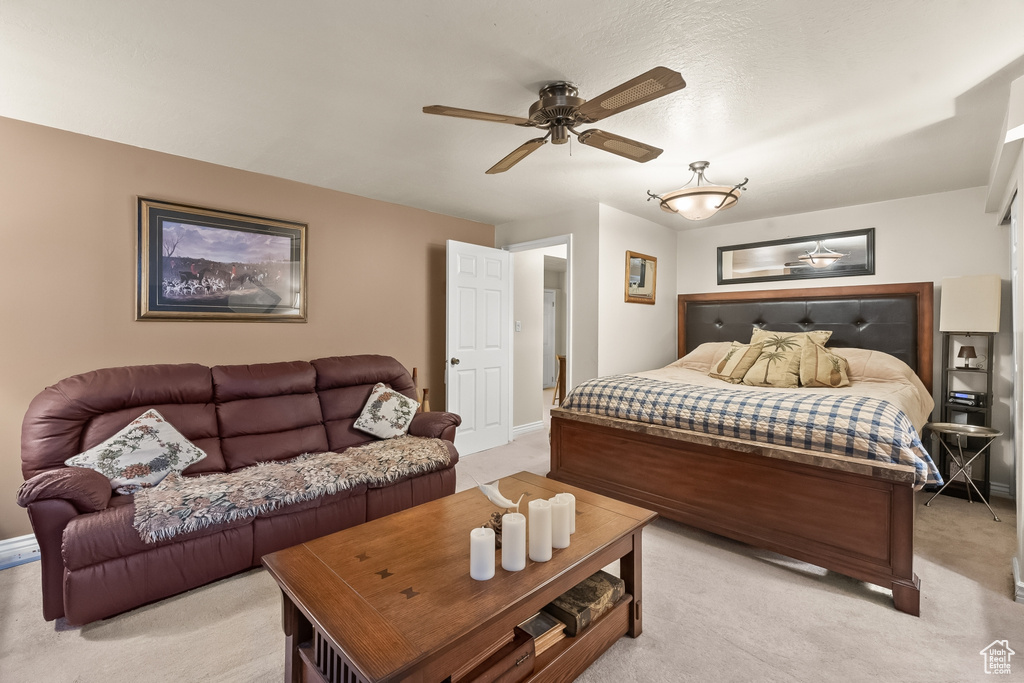 Carpeted bedroom with ceiling fan