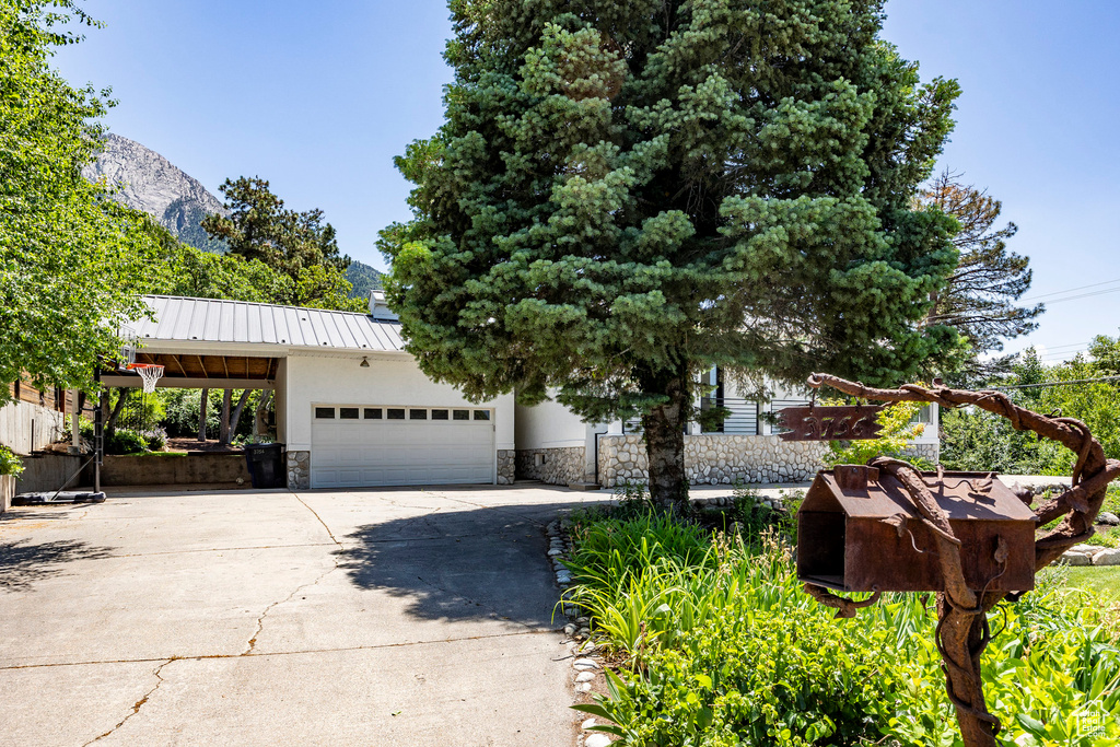 View of front of house featuring a garage and a mountain view