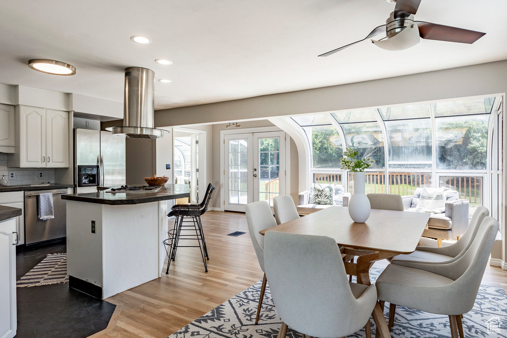 Dining room featuring light hardwood / wood-style floors, french doors, and ceiling fan