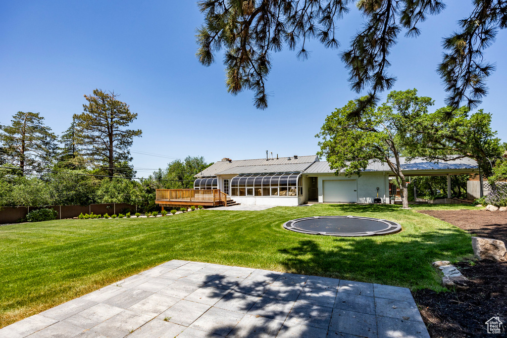 View of yard featuring a patio and a wooden deck