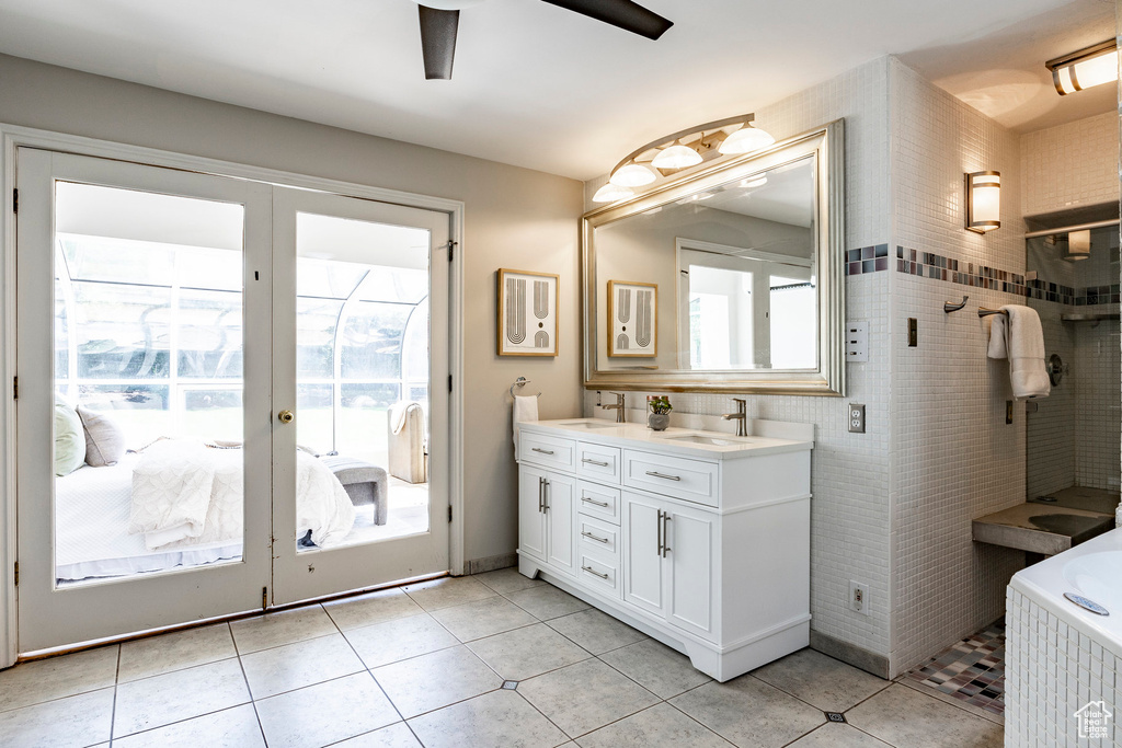 Bathroom with a healthy amount of sunlight, dual vanity, ceiling fan, and tile floors