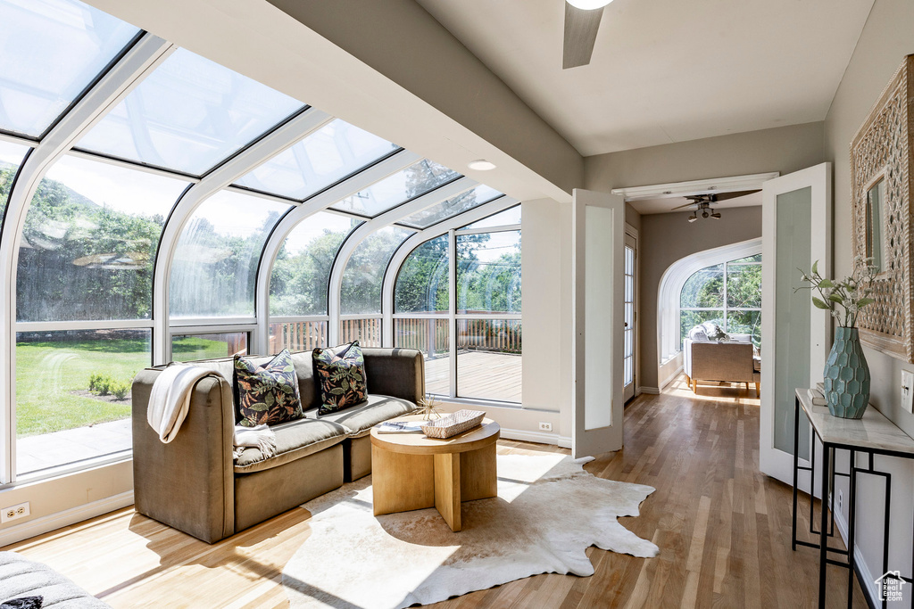 Sunroom featuring ceiling fan and vaulted ceiling with skylight