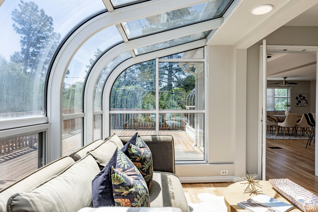 Sunroom / solarium with vaulted ceiling with beams and ceiling fan