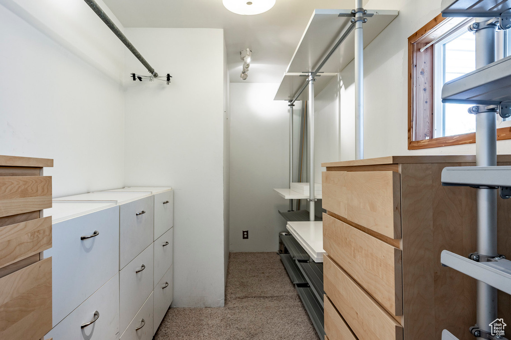 Spacious closet with light colored carpet