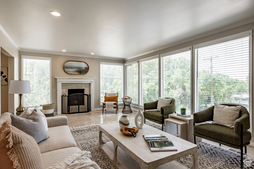 Tiled living room featuring plenty of natural light and ornamental molding