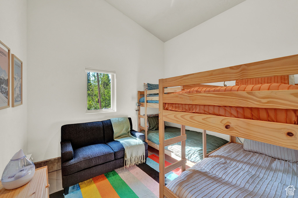 Bedroom with high vaulted ceiling