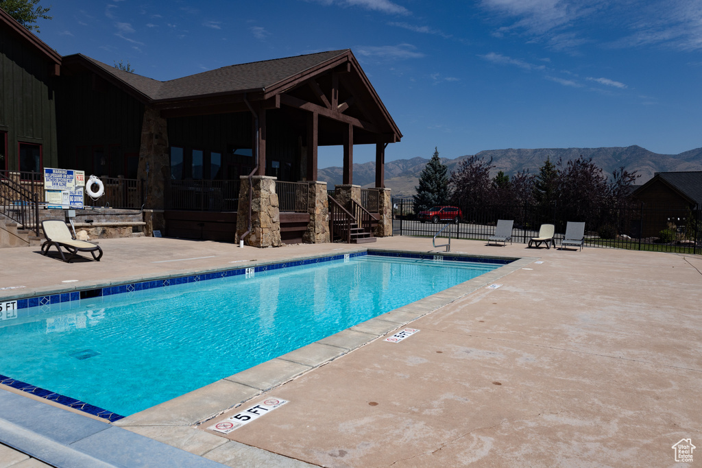 View of swimming pool with a mountain view