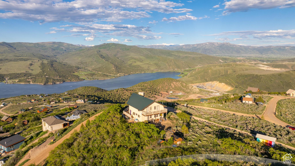 Drone / aerial view with a water and mountain view