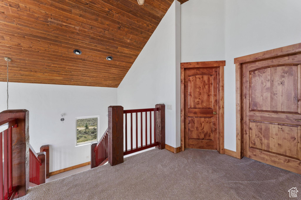 Bonus room featuring high vaulted ceiling, wood ceiling, and carpet