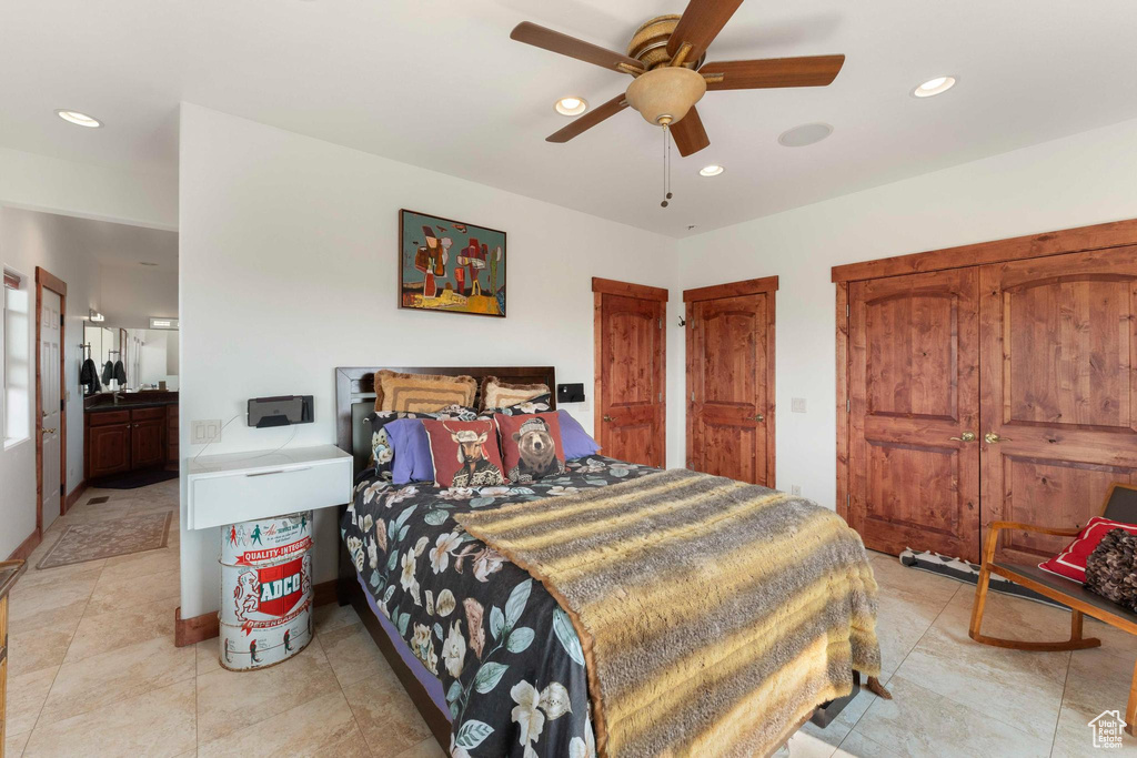 Bedroom with ceiling fan and multiple closets