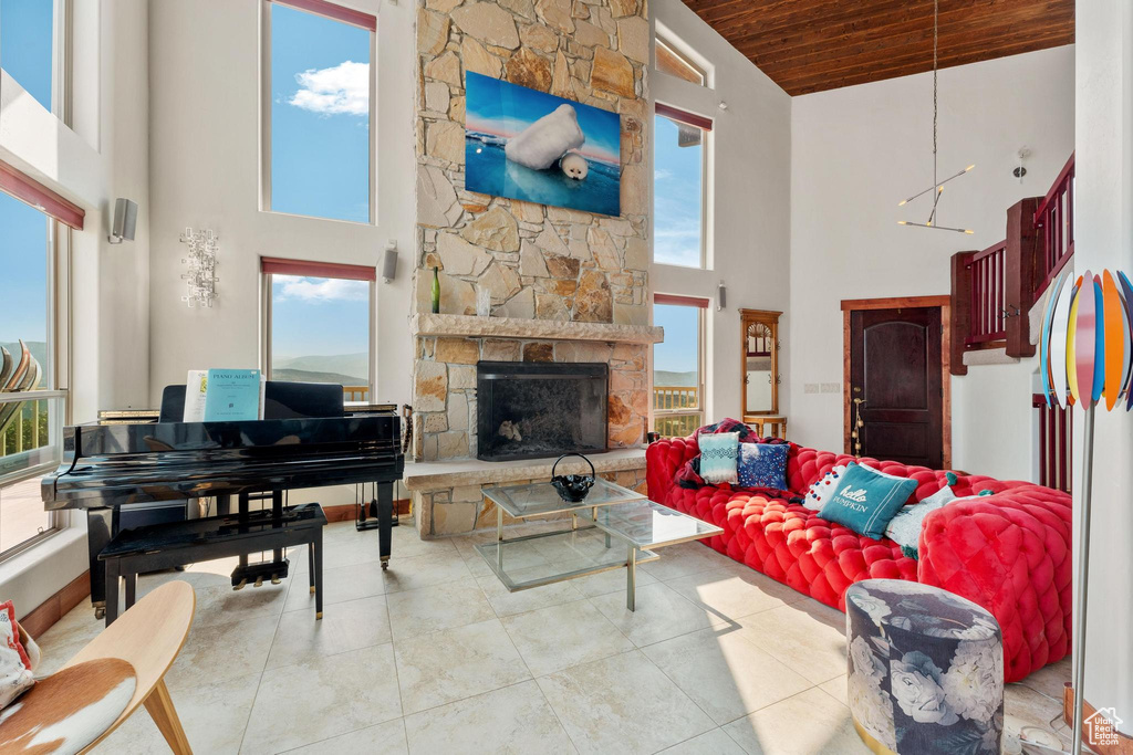 Tiled living room featuring wooden ceiling, a fireplace, and high vaulted ceiling