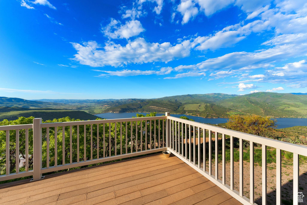 Deck with a water and mountain view