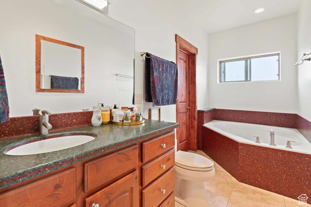 Bathroom featuring tile patterned floors, a bathtub, toilet, and vanity